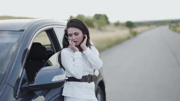 Pretty Woman Making Call and Having a Problem with Car Serviceable alt