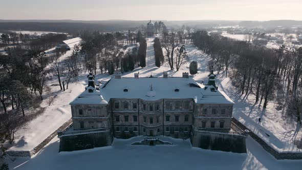Aerial View Drone Flight Backward Over the Historic Old Castle at Sunny Winter Day Pidhirtsi Palace