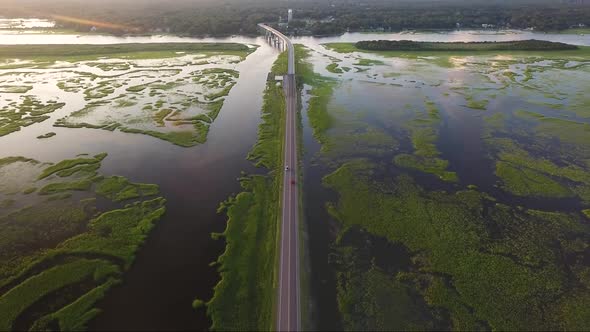 Drone flying over causeway revealing bridge at sunset in Ocean Isle Beach, NC alt
