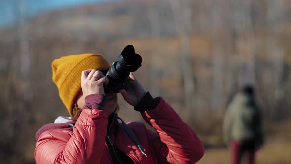 Woman Takes Photo of Autumn