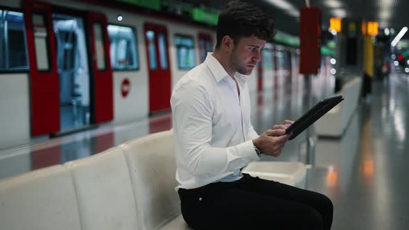 Male Entrepreneur with Tablet in Subway alt