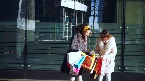 Two Girls Discuss Purchases