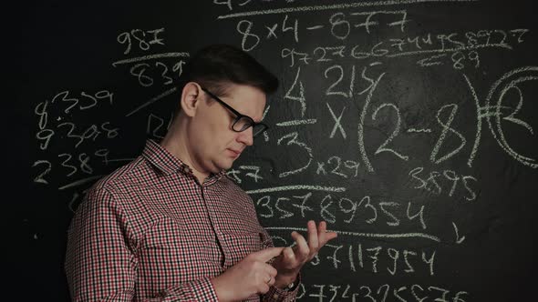 Man Writes Math Formula Blackboard