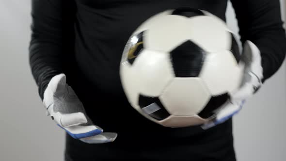 Close Up Goalkeeper Holding Soccer Ball in the Stadium Studio Football Player Hands Professional alt