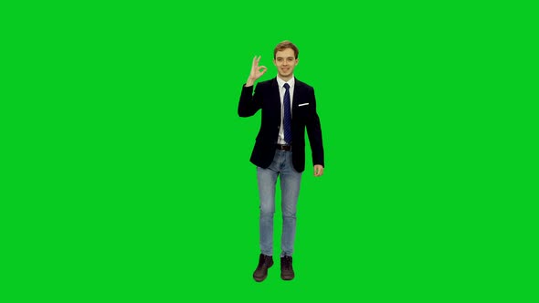 Young Business Man Showing Ok Sign while Walking on Green Screen
