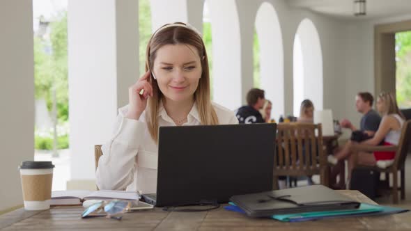Young Caucasian Business Woman with Headphones Communicating Video Call RED 8K alt