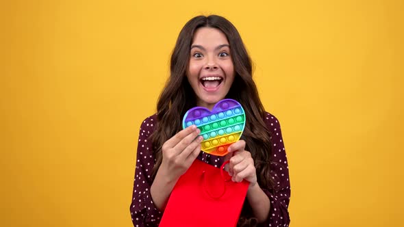 Happy Amazed Child Got Present of Popit Fidget Silicone Sensory Game Showing Toy Present alt