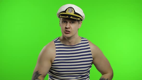 Young Sailor Man Is Angry and Shows Fist Fight. Seaman Guy in Sailor's Vest alt