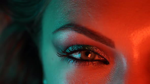 Woman Face, Girl Flirts with Facial Expressions, Moves an Eyebrow. Neon Light. Female with Beautiful alt