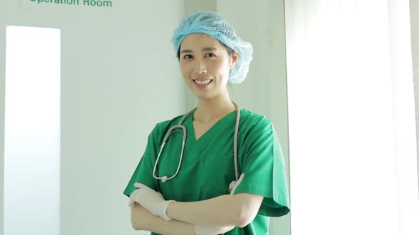 Asian professional female surgeon standing in front of the operating room alt