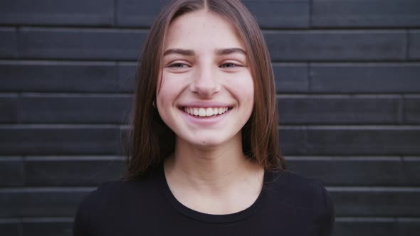 Portrait of Beautiful Young Woman with Attractive Smile alt