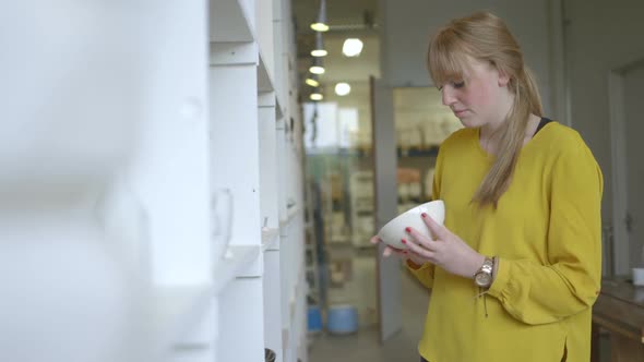 Male potter using digital tablet in workshop