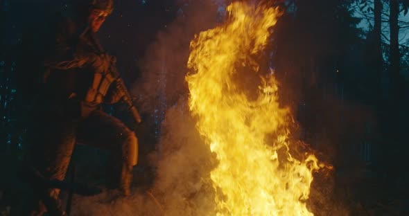 Military Operatives Going Thorugh Action and Juping Over Fire in Dense Forest at Night Concept of alt