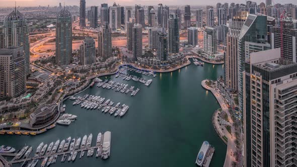 Dubai Marina Skyscrapers and Jumeirah Lake Towers View From the Top Aerial Night to Day Timelapse in alt
