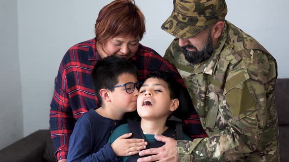 Military soldier being welcomed home by his family