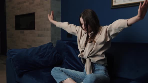Young Woman Taking a Deep Breath Whilst Meditating in Her Living Room Lotus Pose Yoga Relaxation alt