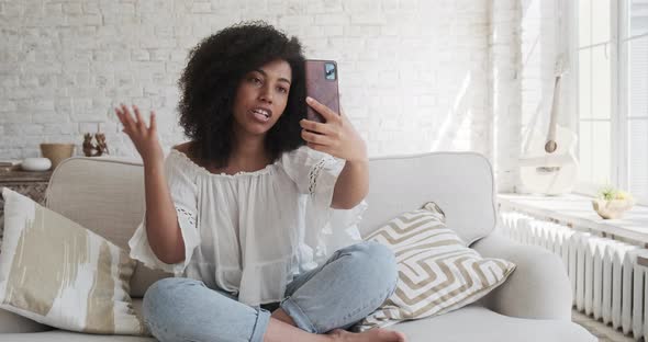 Young Black Woman Communicating on a Video Call with Friends Using Her Phone Recording Educational