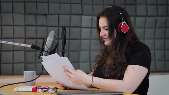 Podcast production process on the sound recording home studio, voice artist puts headphones on alt