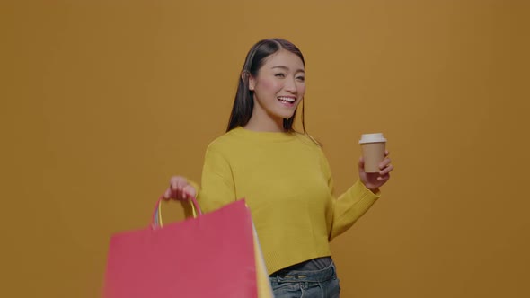 Positive Adult Posing with Shopping Bags and Cup of Coffee alt