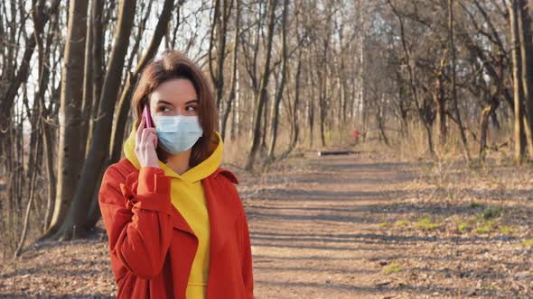 COVID-19 Coronavirus Infection Woman Dressed in Orange Red Coat Wearing Protective Face Mask Walking