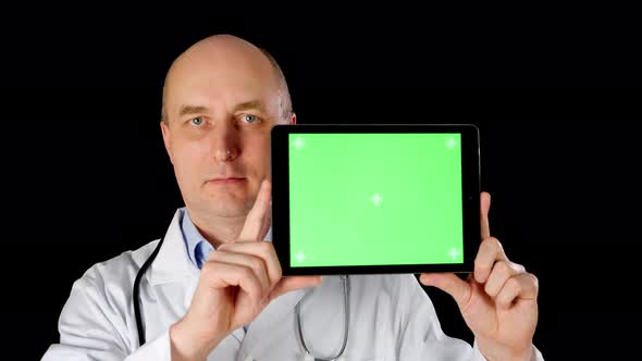 Front View of Doctor Holding Tablet with Green Screen alt