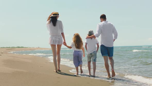 Family walking along coast and talking alt