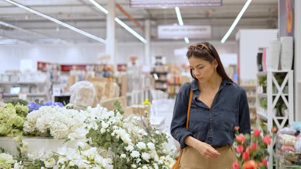 Young Female Customer Buying Artificial Flowers for Home Decor alt