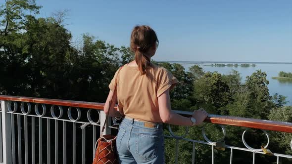 Woman tourist standing on bridge