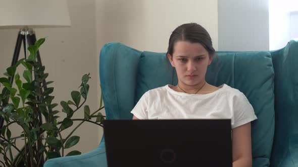 Authentic Young Woman Chatting On Laptop In Living Room alt
