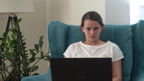 Authentic Young Woman Chatting On Laptop In Living Room