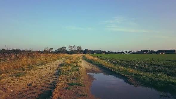 Aerial Cinematic Clip Drone Flying Over a Farm Field During Sunset alt