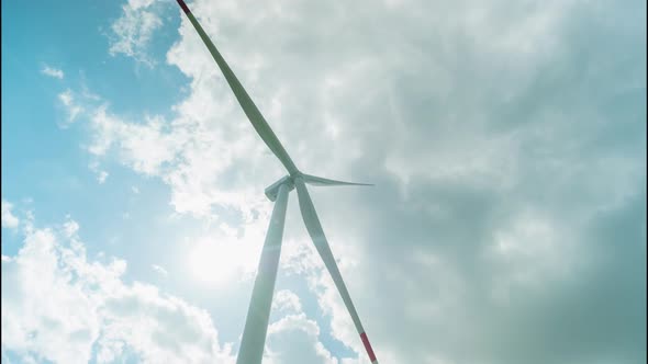 Wind Turbine Produces Clean Energy Under Sky with Clouds