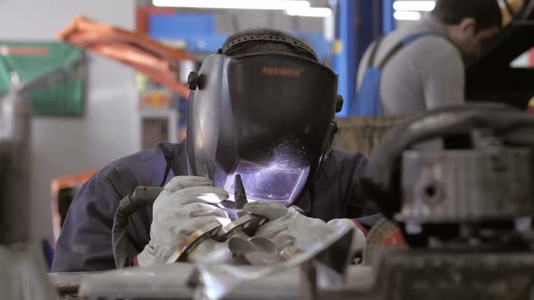 Welding Process. Worker Doing Welding Job. A Man In Helmet Doing Argon Welding Parts