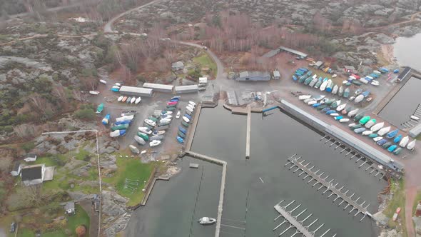 Small and Empty Marina and Winterized Boats Aerial Circling