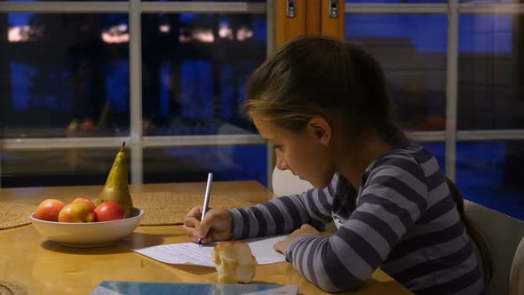 Pretty School Girl at Home, Writing a Homework. Child Sitting at Table and Write a Letter With Pen.