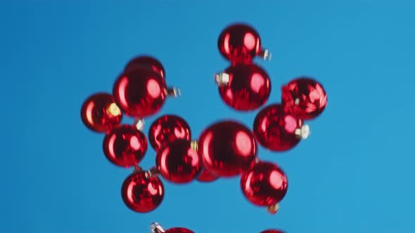 Flying Christmas Balls Against Blue Background