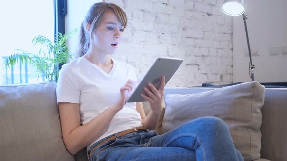 Reaction to Loss by Woman Using Tablet in Bedroom alt