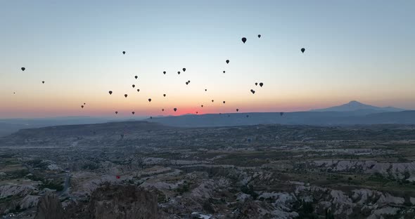 Aerial Cinematic Drone View of Colorful Hot Air Balloon Flying Over Cappadocia alt