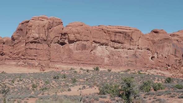 Red Orange Massive Cliff Formation In Arches Park On A Sunny Day In Motion alt