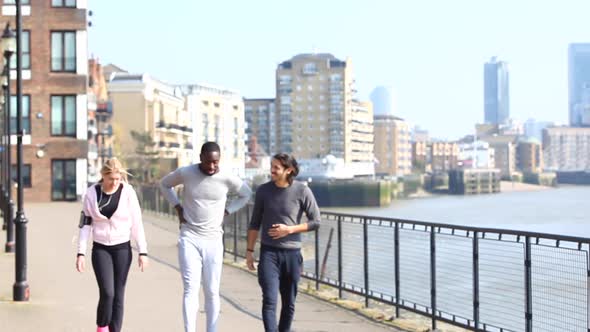 Multiracial people walking together after running and training