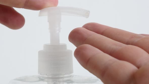Sanitizer gel pump and hand close-up 4K video alt