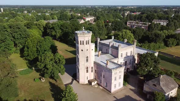 Vecauce Manor in Latvia Aerial View of the Pink Castle Through the Park. alt