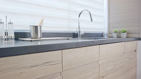 Tracking shot of a luxury kitchen with wood finish modern design alt