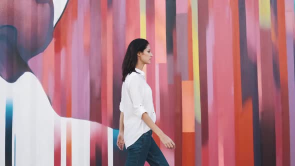 Attractive Girl of European Appearance Walks Down the Street Smiling