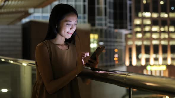 Woman use of smart phone in city at night  alt