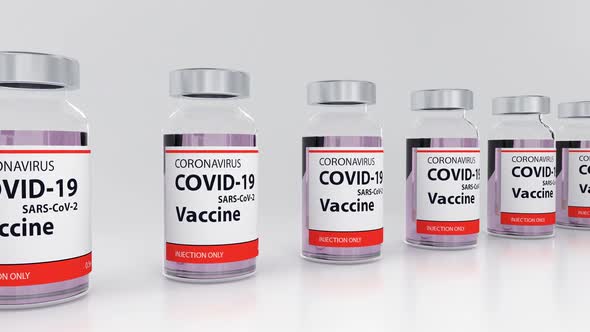 Ampoules with Coronavirus Vaccine in the Row Against White Background Loop alt