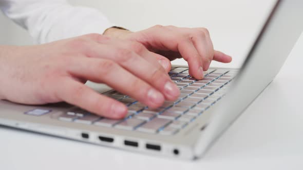 Hands typing on a laptop alt