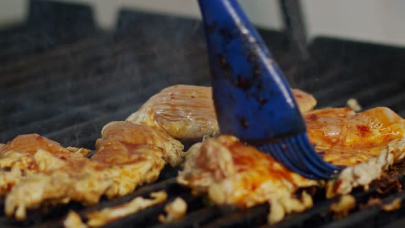 Close up of chicken breast roasted on a grill with flames