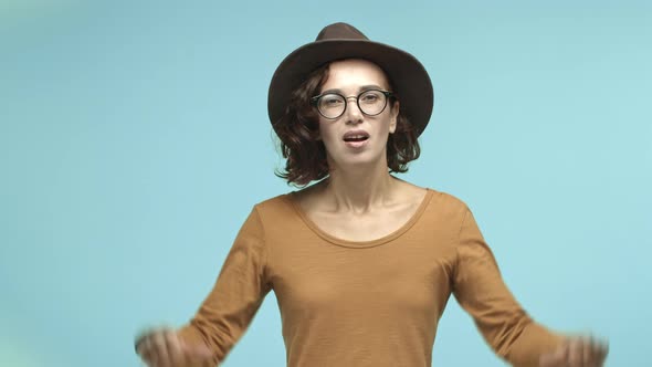 Young Woman Tourist in Glasses and Hat Grimacing From Disappointment Showing Thumbsdown Dislike
