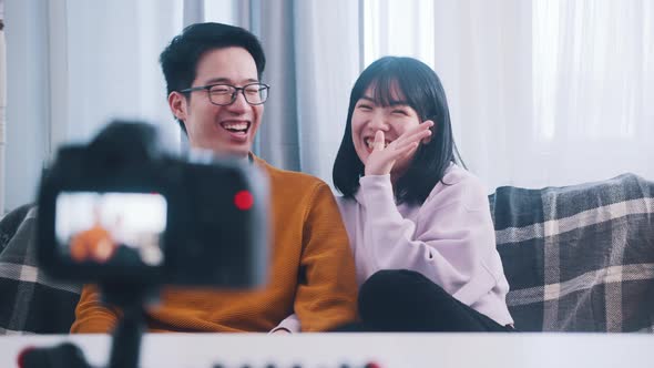 Young Asian Couple Influencers Streaming From the Comfort of Their Home alt